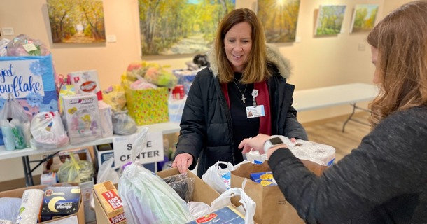 Cindi Richter, Foundation (left) and Anna Fryda, Communication (right) load items donated by Good Samaritan staff onto a cart for the Safe Center. Donated items included diapers, food, clothing and personal hygiene products to help support those affected by domestic violence. 